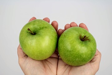 Green apples held in hands