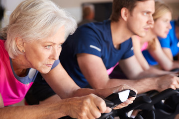 Close Up Of Group Taking Spin Class In Gym