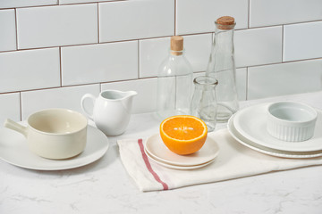Orange in a dish on the table in the kitchen