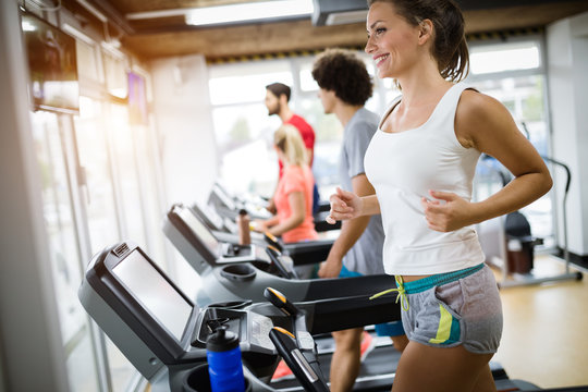 Group of friends exercising on treadmill machine