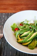 Avocado Arugula and cherry tomatoes salad with light dressing