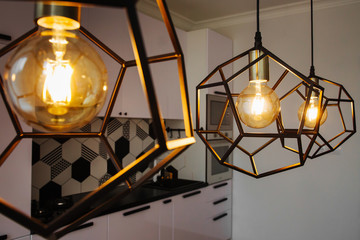 Lamp in modern style with Edison's light bulb. Warm tone light bulb lamp. Stylish interior.
