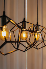 Lamp in modern style with Edison's light bulb. Warm tone light bulb lamp. Stylish interior.