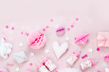 Pink and white Paper Decorations, pom-pom, candy, hearts, gifts, confetti for Baby party. Birthday concept.  Flat lay, top view