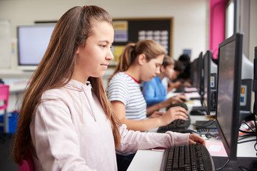 Line Of High School Students Working at Screens In Computer Class