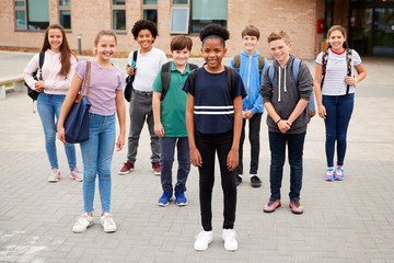Obraz premium Portrait Of High School Student Group Standing Outside School Buildings
