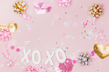 Fototapeta na wymiar Confetti, bows and paper decorations. Valentines day or birthday party concept theme. Flat lay, top view.