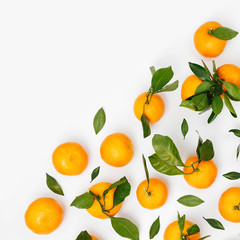 Fresh orange Mandarins, tangerine with green leaves on white background. Flat lay. Top view