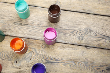 paint bottels on rustic wooden background