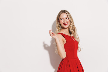 Portrait of a smiling young woman in red dress - obrazy, fototapety, plakaty