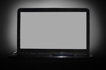 black laptop on black background with reflection