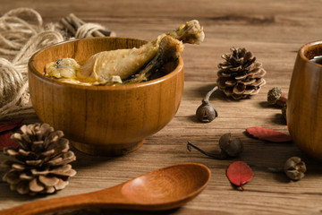 chicken soup with wooden background