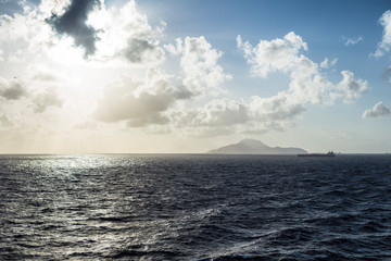 Ocean landscape with mountains and a ship