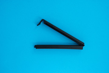 Plastic sealing clip on red and blue background.