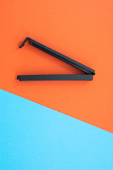 Plastic sealing clip on red and blue background.
