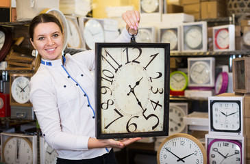 woman is demonstraiting wall clock