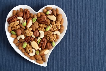 Nuts on a plate in the shape of a heart.