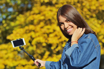 A young girl of Asian appearance uled makes a selfie