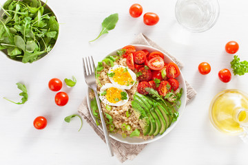 quinoa with boiled egg, avocado, tomato, arugula. healthy breakfast