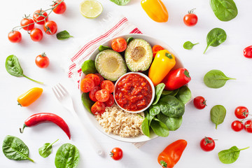 vegan buddha bowl. healthy lunch bowl with avocado, tomato, bell peppers, quinoa and salsa