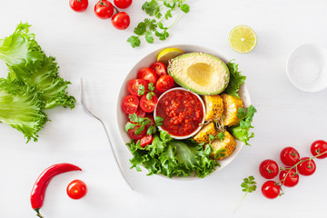 vegan buddha bowl. healthy lunch bowl with avocado, tomato, sweet corn and salsa