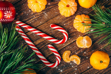 Christmas new year background with tangerines and sweets on the table.