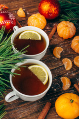 Christmas new year background with tangerines, tea and sweets on the table.