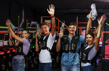 people with laser guns having fun together in dark labyrinth