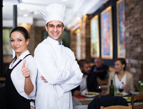 Waitress with chef in restaurant