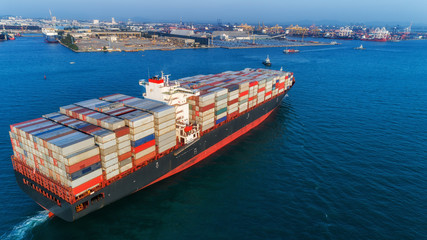 Aerial view container ship going to sea port for unloading container to container warehouse for...