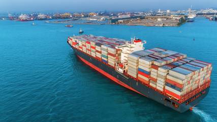Aerial view container ship going to sea port for unloading container to container warehouse for...
