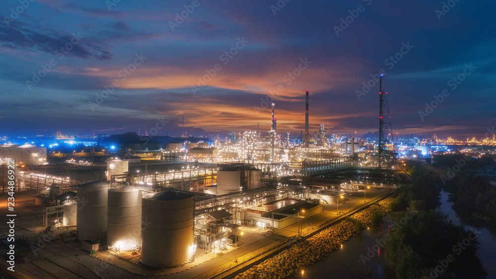 Wall mural oil refinery factory at dusk for energy or gas industry or transportation background.