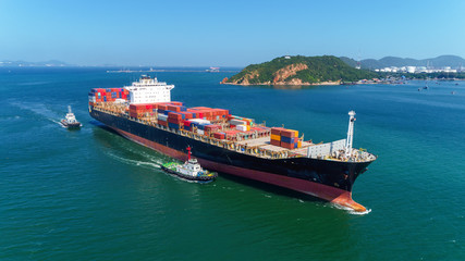 Tug boats drag container ship to sea port for unload container to container warehouse for logistics import  export, shipping or transportation concept background.
