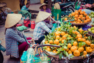 Fresh vegetables and fruits in traditional street market in Hanoi, Vietnam.