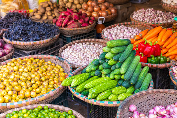 Fresh vegetables and fruits in traditional street market in Hanoi, Vietnam.