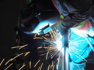 Welding work, worker with protective welding metal on construction