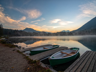 Naklejka na ściany i meble Morning scenery with boats moored on Hintersee lake at sunrise