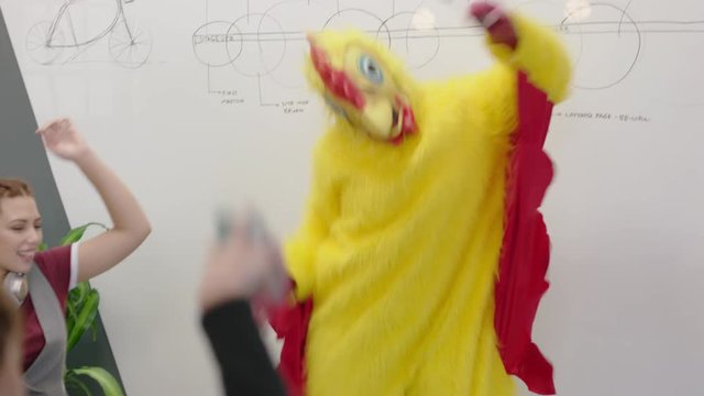 dancing chicken happy business students enjoying funny dance party in boardroom meeting celebrating successful victory crazy rooster high five colleagues in excited office presentation