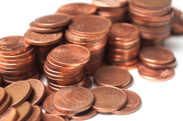 closeup of cents of euro coins piles on white background