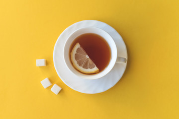 Cup of tea with lemon and sugar.