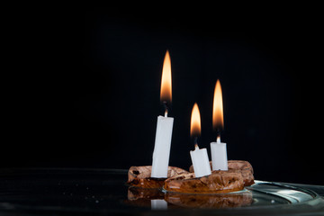 Christmas candles in walnut shell on water surface