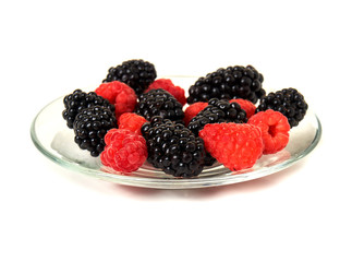 Blackberry and raspberry on glass plate isolated on white background clipping path