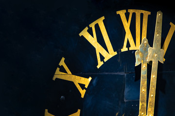 The clock with gilded Roman numerals shows twelve hours. The midnight on tower clock.