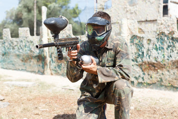Fototapeta premium Adult male player aiming and shooting with gun