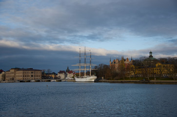 Fototapeta premium A full-rigger, commuting boats and Old steamboats at Blasieholmen and Skeppsholmen islands in Stockholm