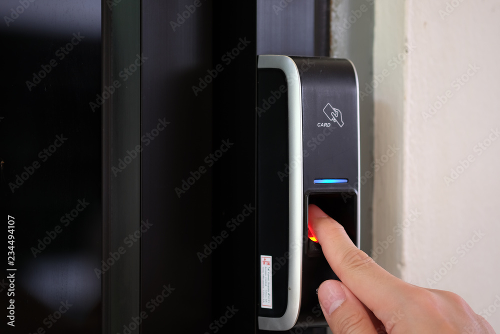 Aufkleber close up of a man paste finger to biometric fingerprint scanner. security, door access control, vali