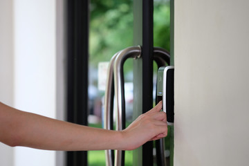 Man paste finger to biometric fingerprint scanner for track employee hours. Security, Door access...
