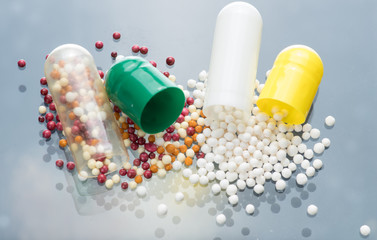 Contents of the capsule with the drug, multi-colored and white microgranules