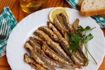 European anchovy fried with lemon and parsley garnish