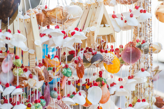 close up Hanging decor by sea shells at street shops, product hand made, decoration at home 
